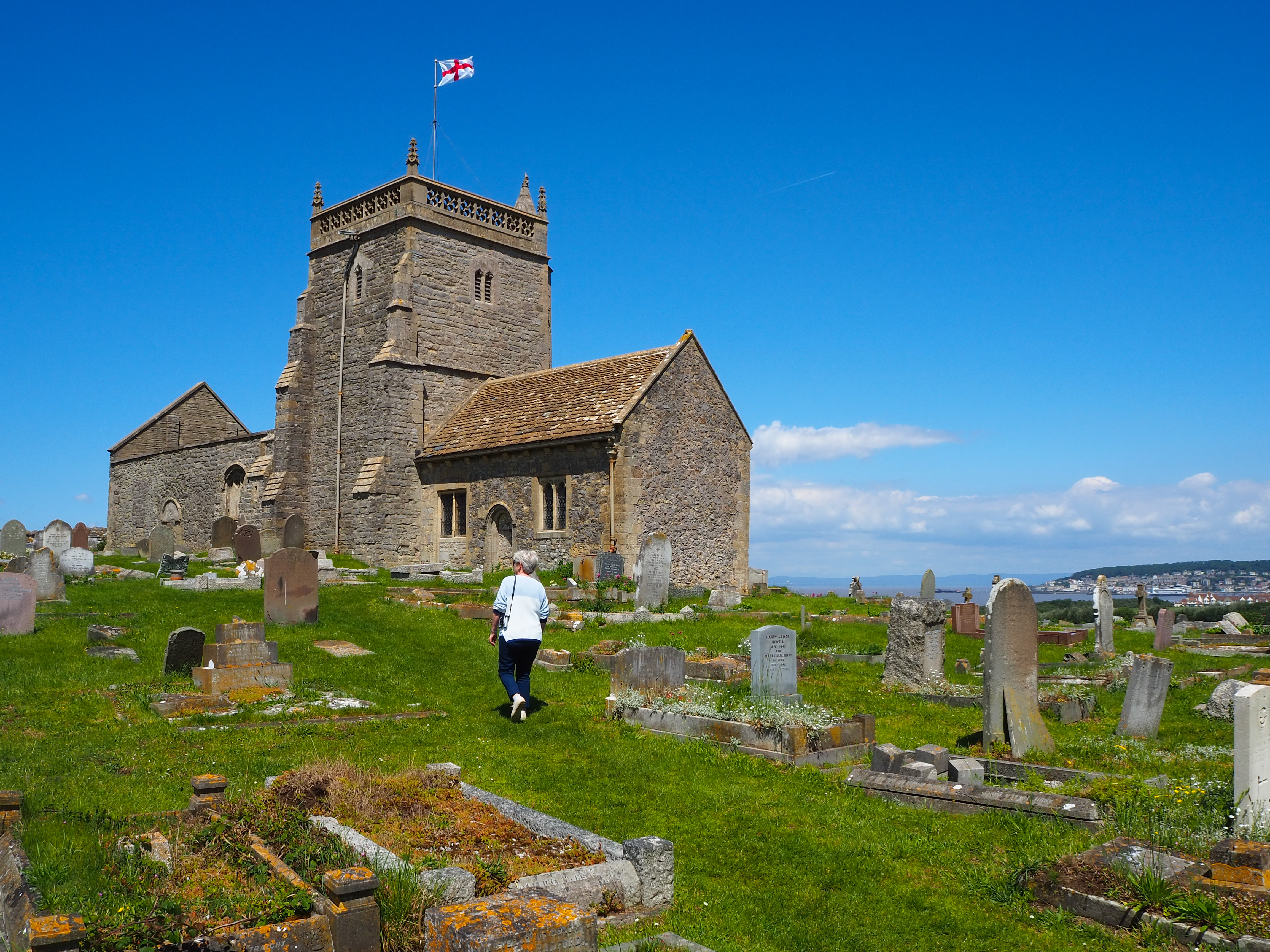 The churchyard of St Nicholas at Uphill with the old Norman church by French Travel guide book author Neal Atherton