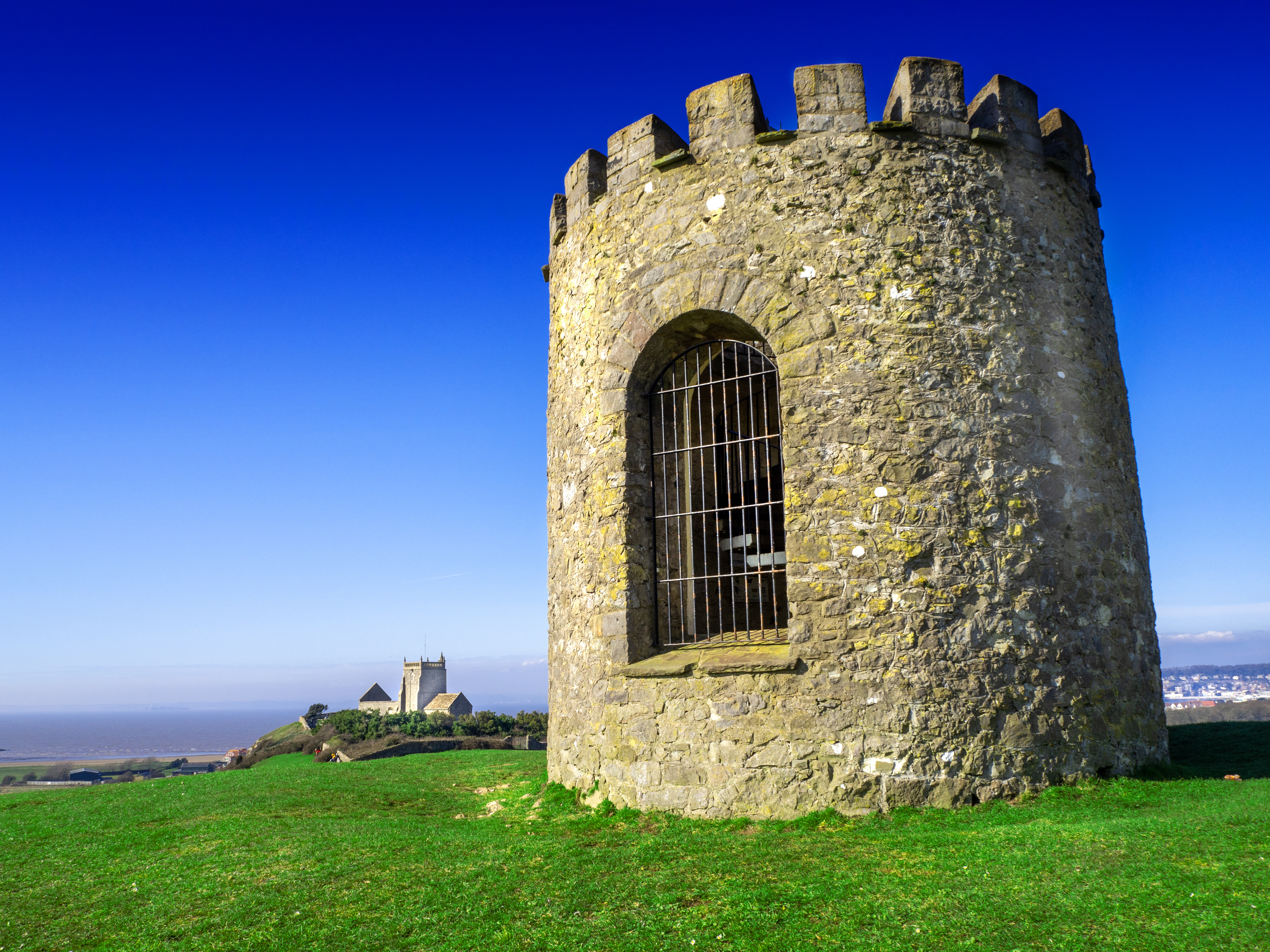 Uphill church of St Nicholas and the old tower windmill looking out over the Bristol Channel by French travel guide book writer