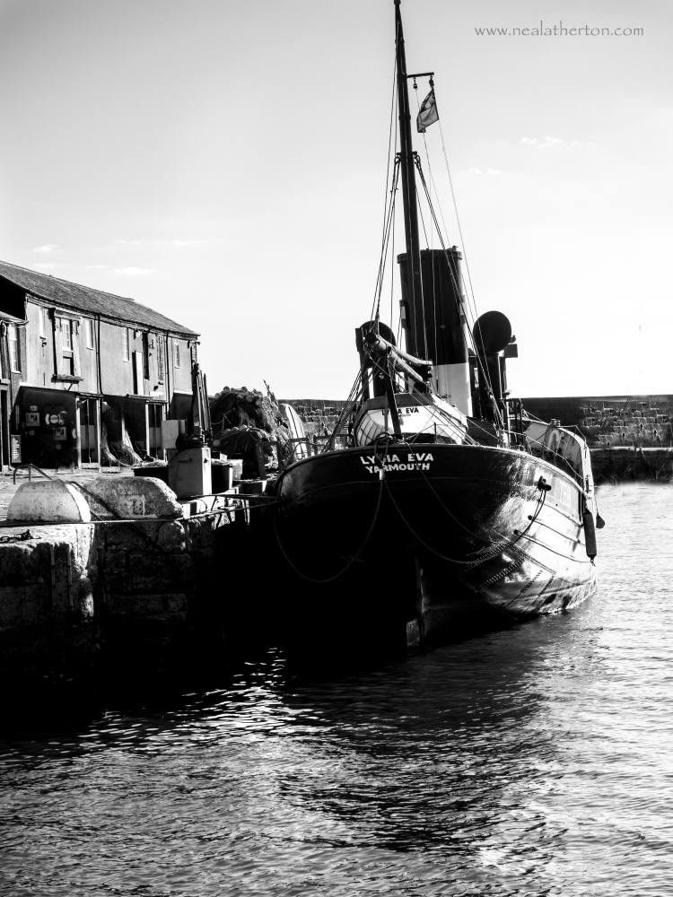 Alt="Black andwhite ship of Lyme Regis Harbour"