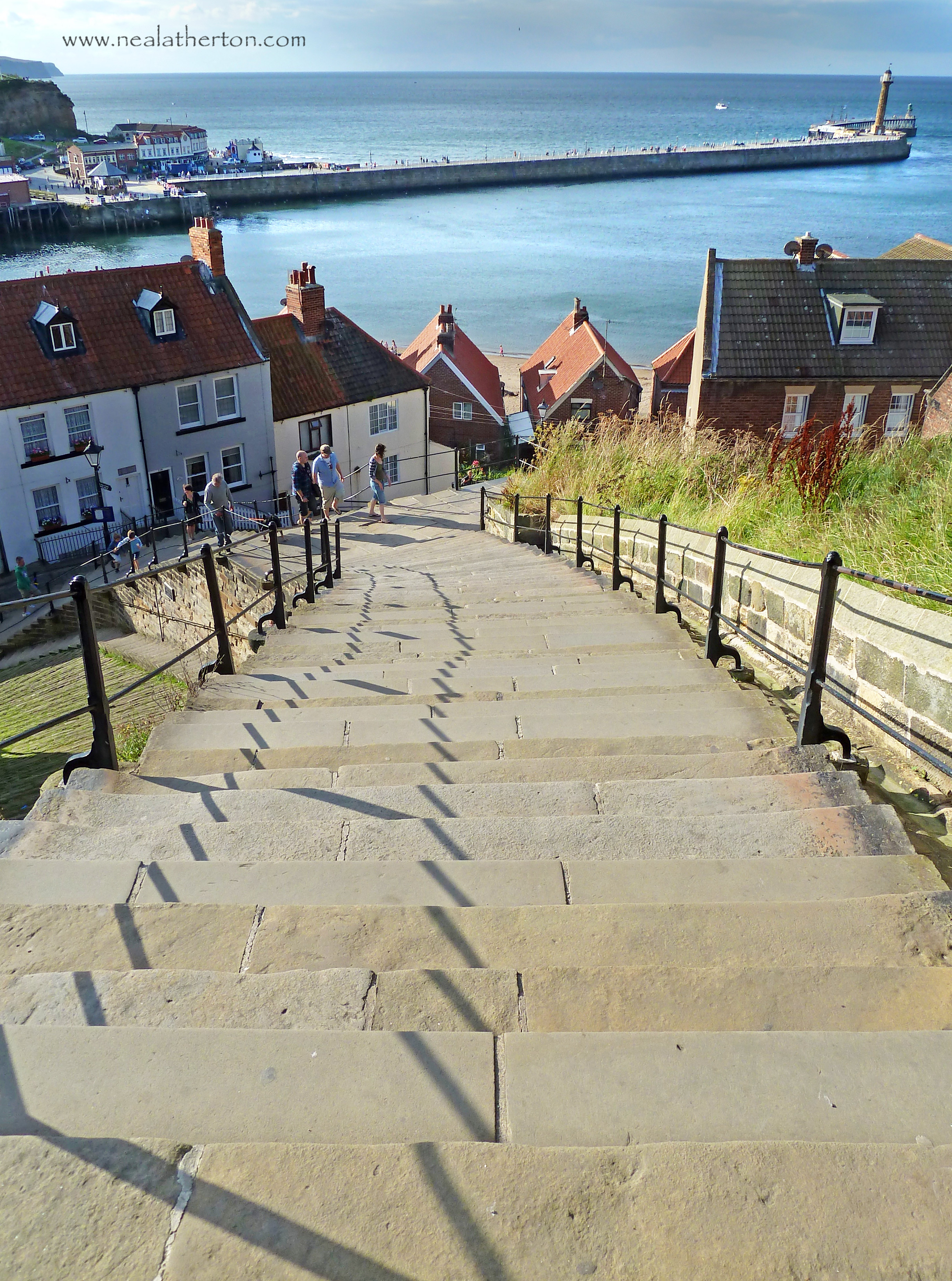 Alt="Photo of the steps leading up to Whitby church and Abbey ruins"