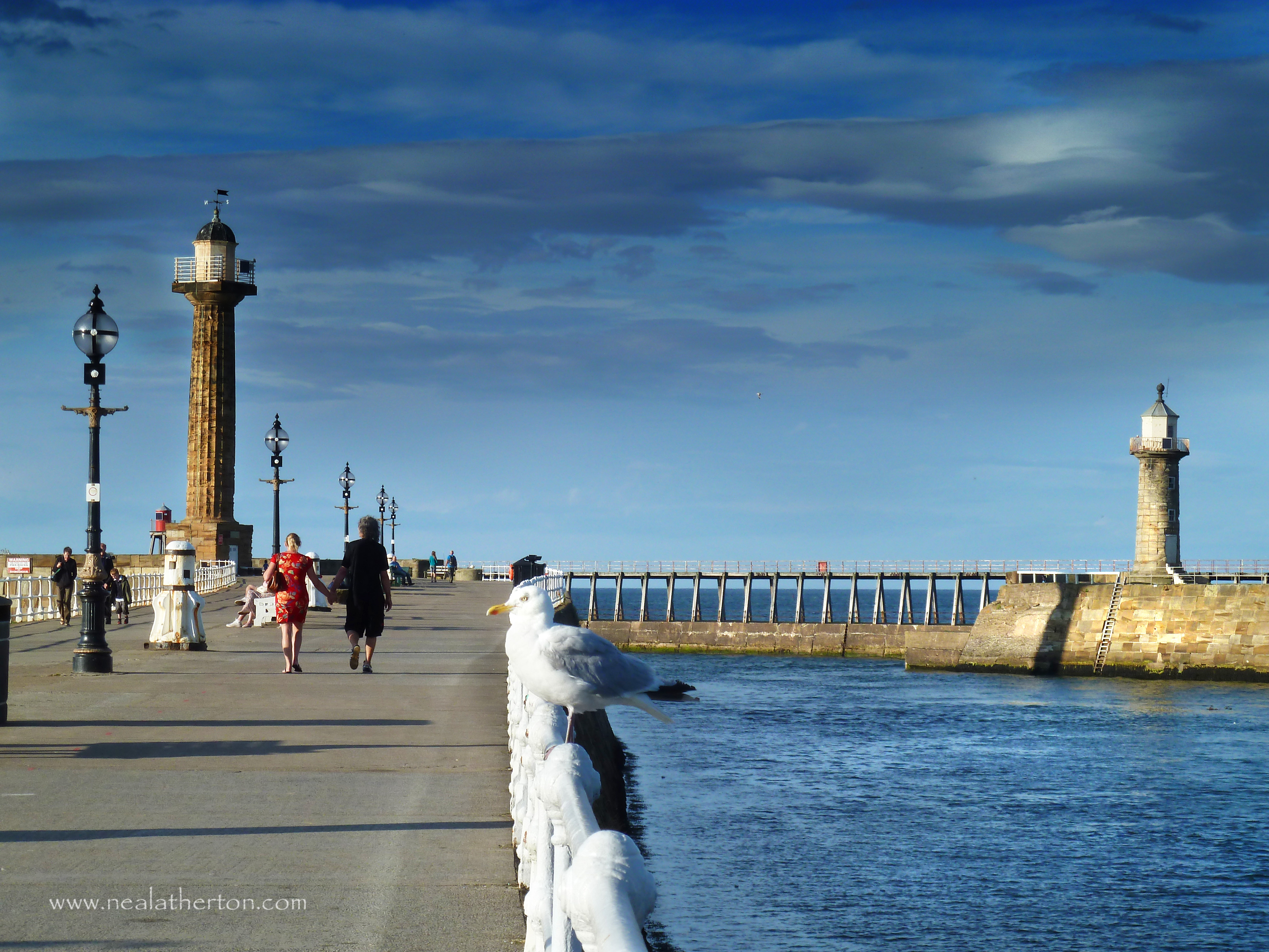 Alt="Photo of Whitby harbour entrance with twin lighthouses"