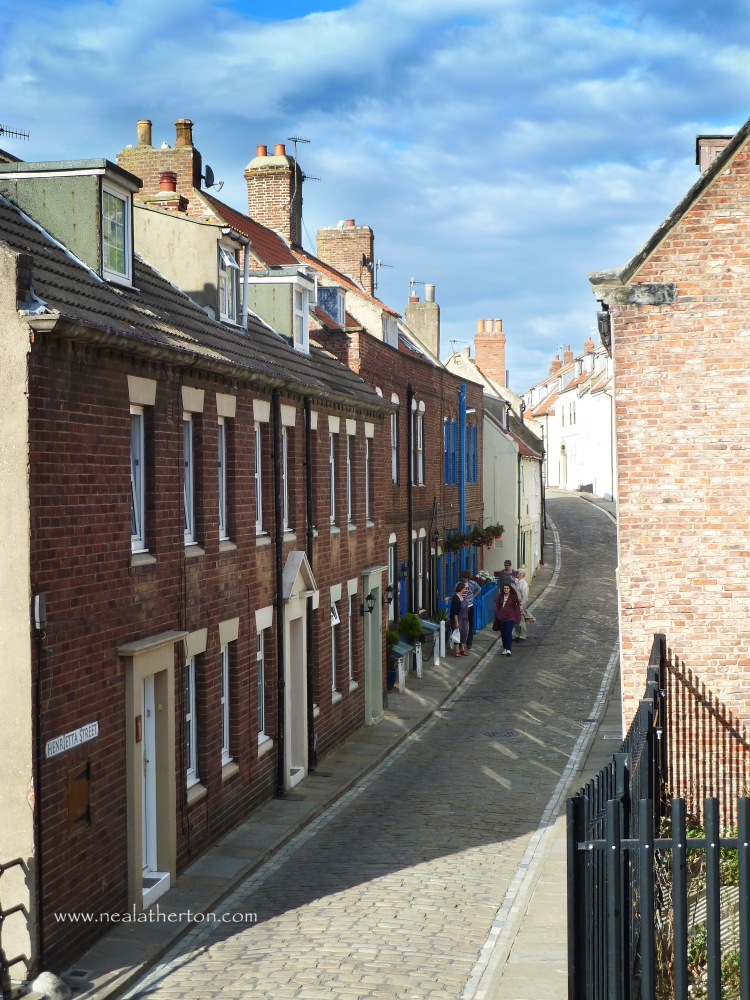 Alt="cobbled street with terraced houses in Henrietta Street Whitby Fortunes kippers"