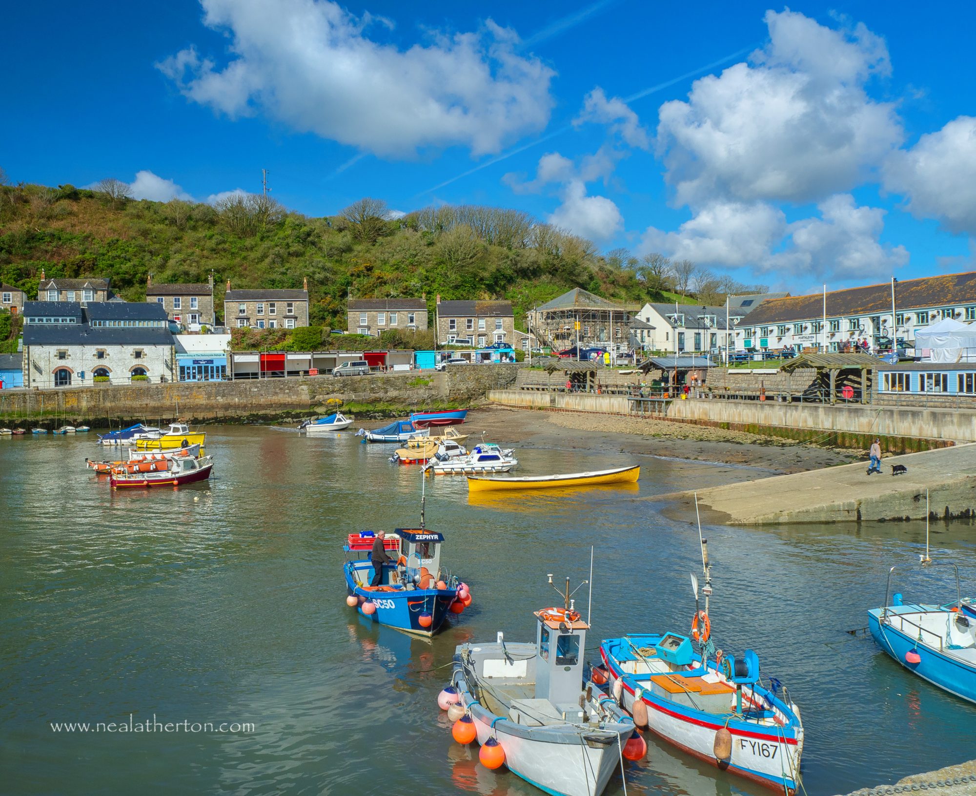 boats in Porthleven harbour including the oner from the Cornish gig club