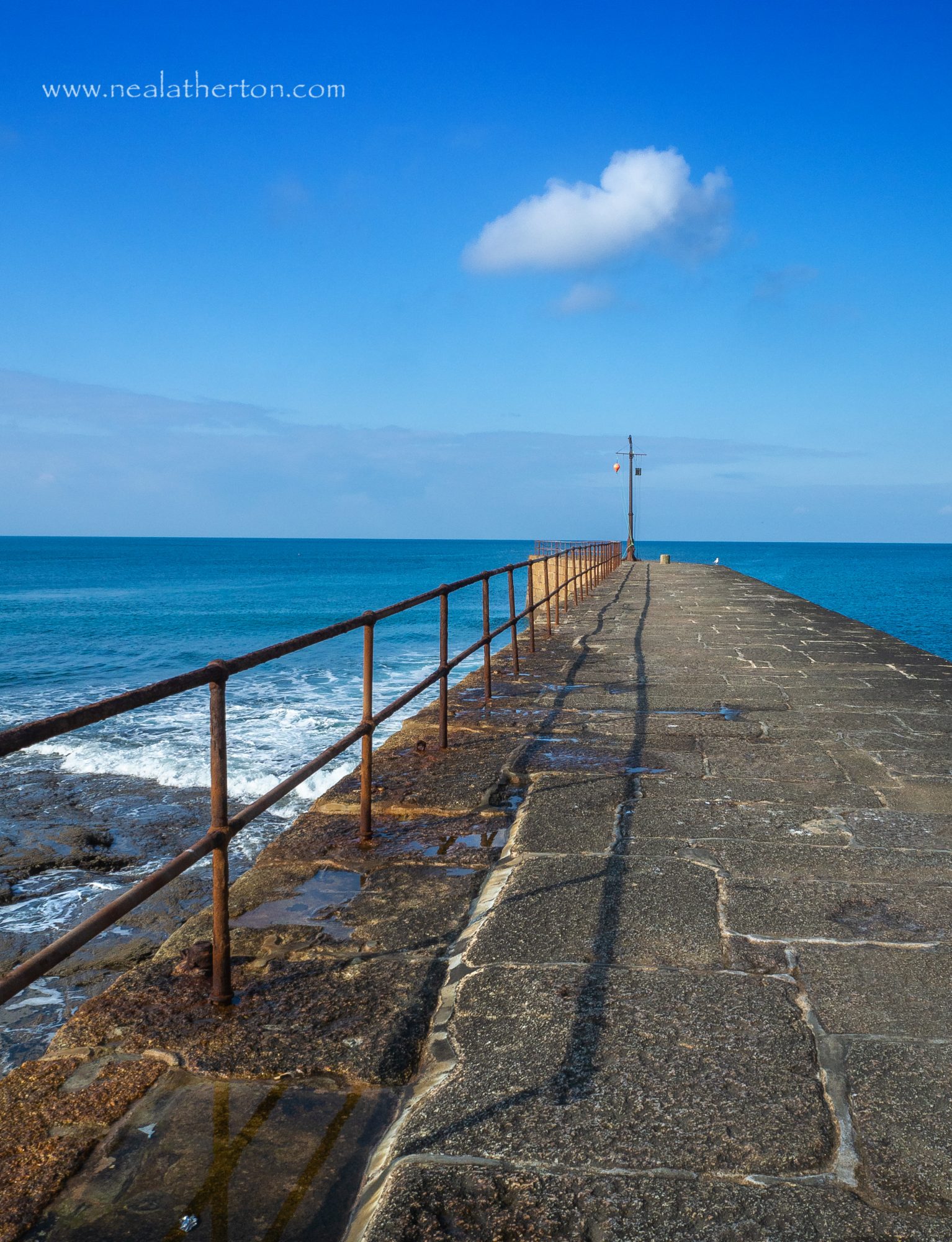 Porthleven old stone pier in Cornwall is a dangerous spot at high tide