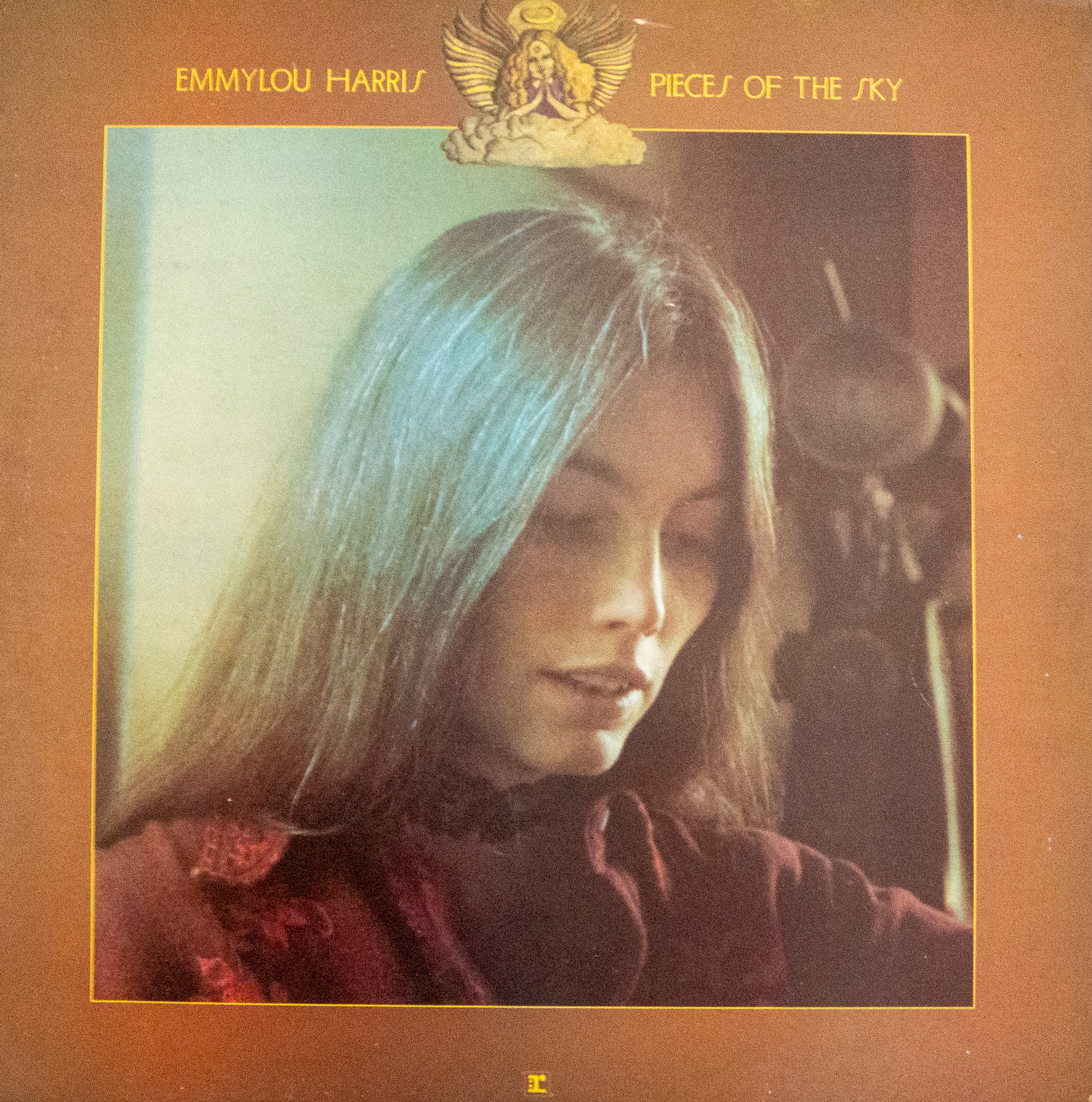 My vinyl copy of Emmylou Harris album Pieces of the sky with her looking wistful an the cover
