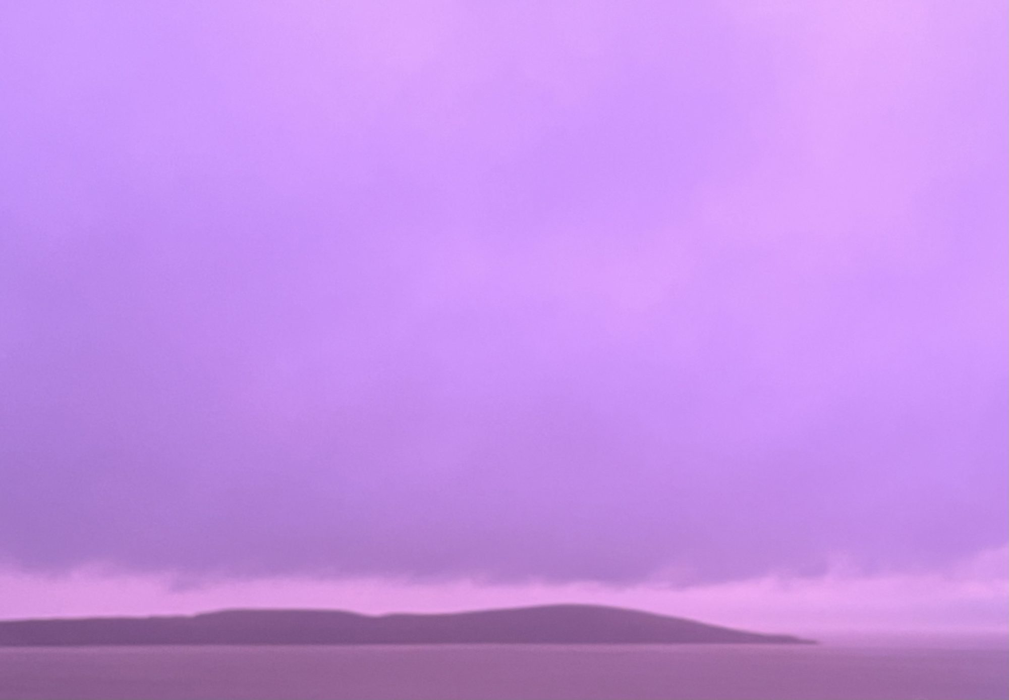 Brean Down Somerset is shown through heavy rain as the sky turns a vivid array of colours here in Somerset England