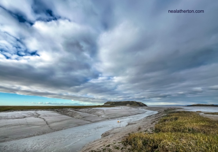 Estuary at low tide with stormy clouds coming over the land at Brean Down Somerset