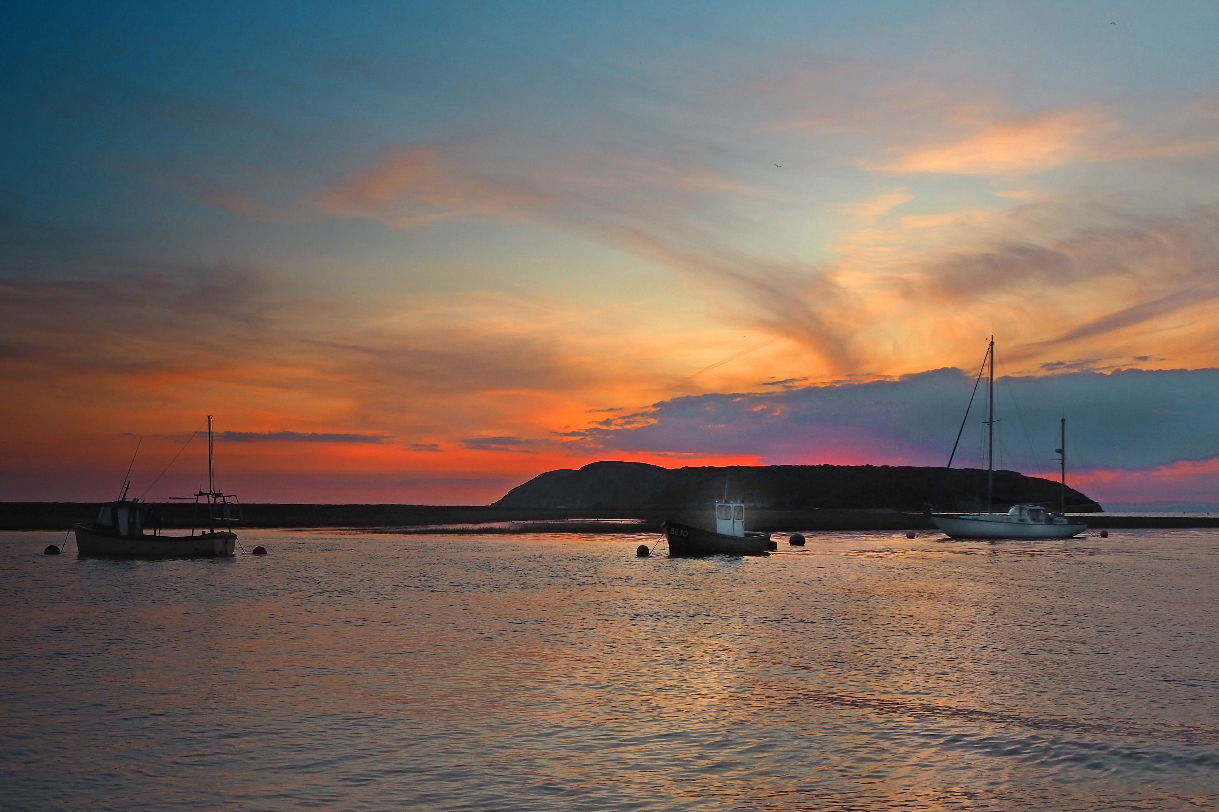 boats and yachts moored in bay at evening red sunset