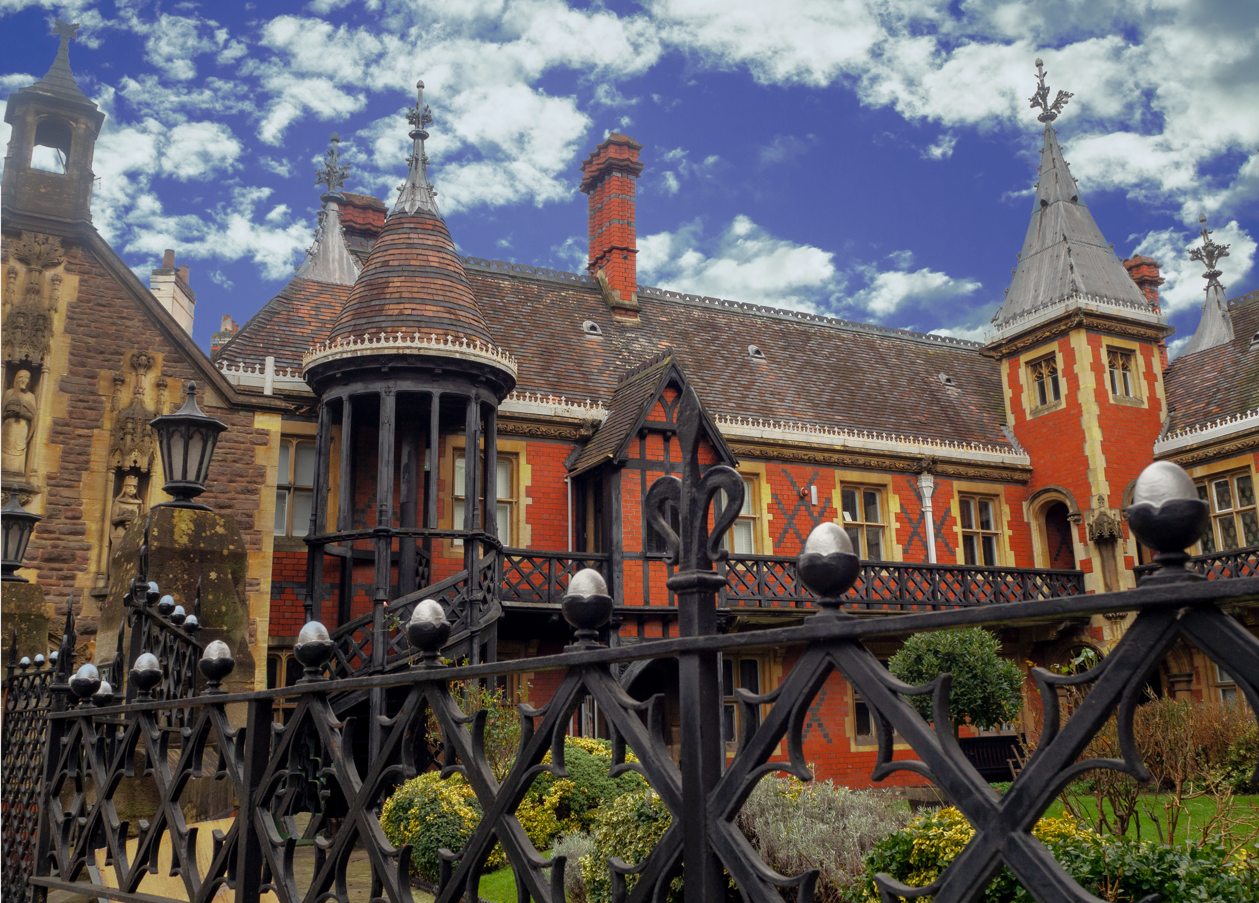 iron railings in front of garden at houses in bristol with tiled roofs and coloured brickwork