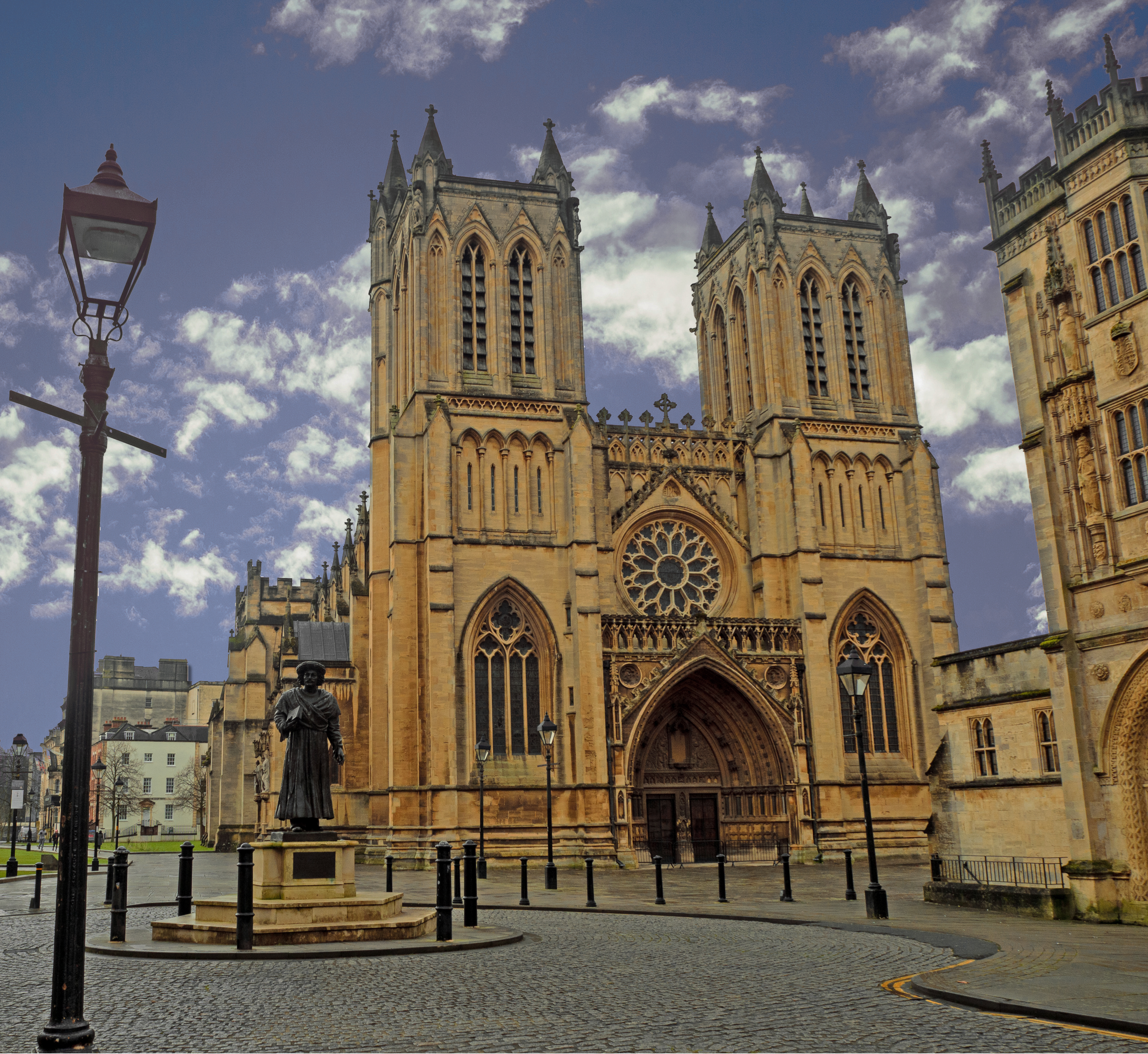 lampost in front of cathedral in bristol uk with statue in front and cobbled street