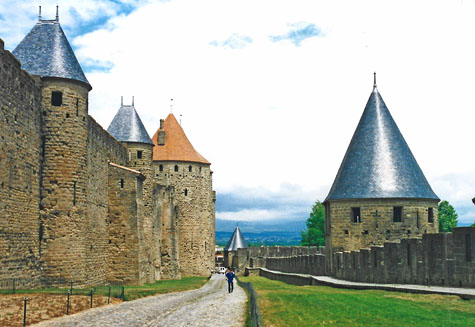 Pointed turret towers and ancient stone walls around a city