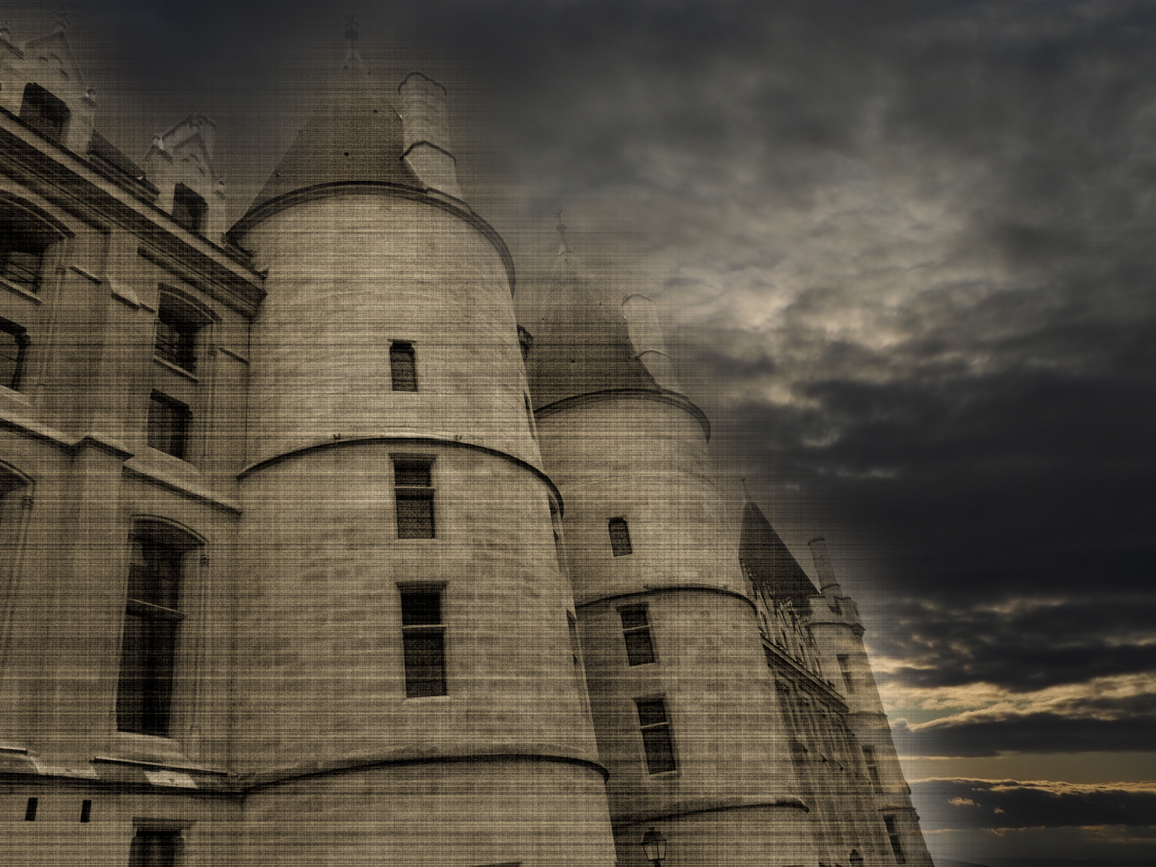 medieval tower on building with windows and dark clouds above in moonlight