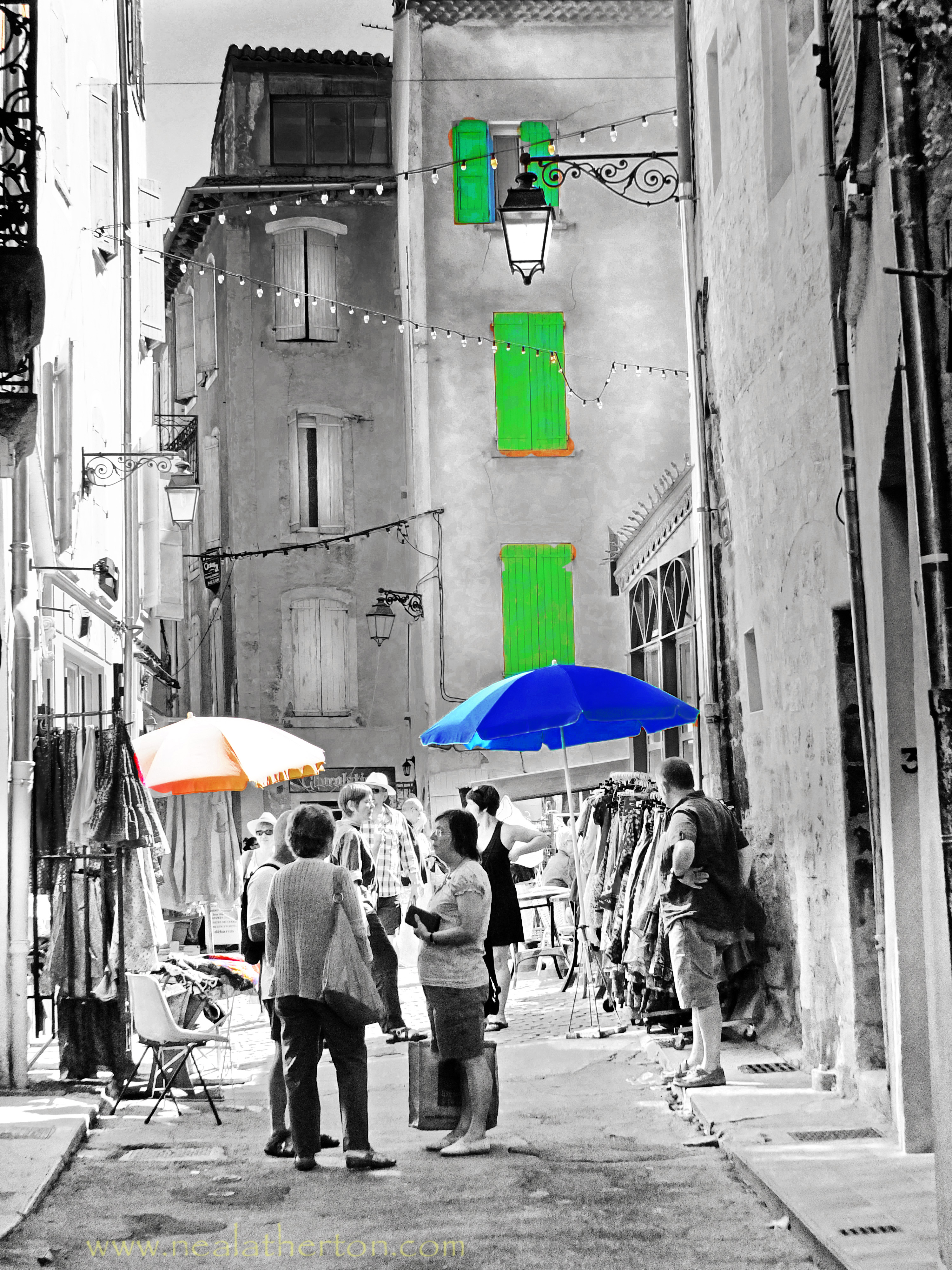 parasol in ancient steeet with high buildings and wooden shutter people talking and market stalls