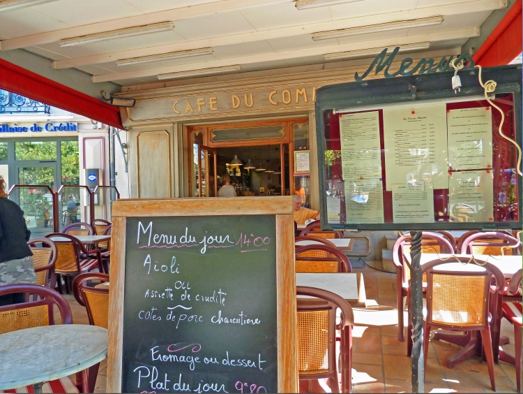 menu board on terrace of restaiurant cafe in FRance with tables and chairs