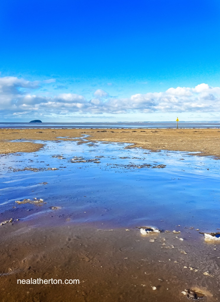 Ice forms on the beach pools in front of Weston bay with steep holm island in the background