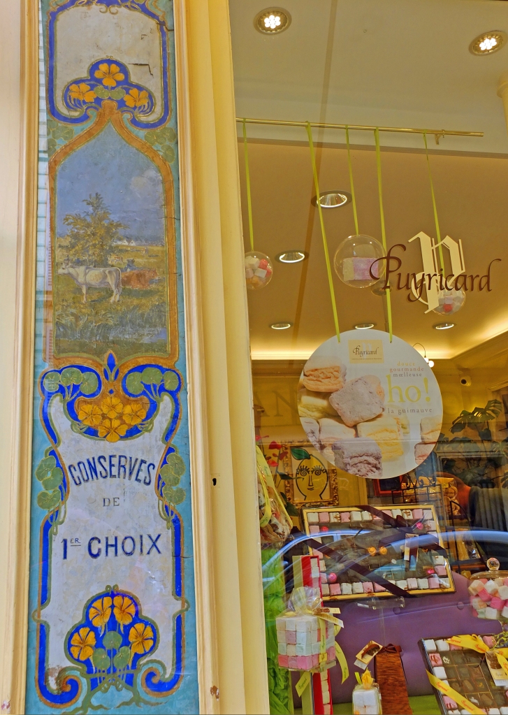 shop window with gold frame with mirror decorated front and chocolates in window