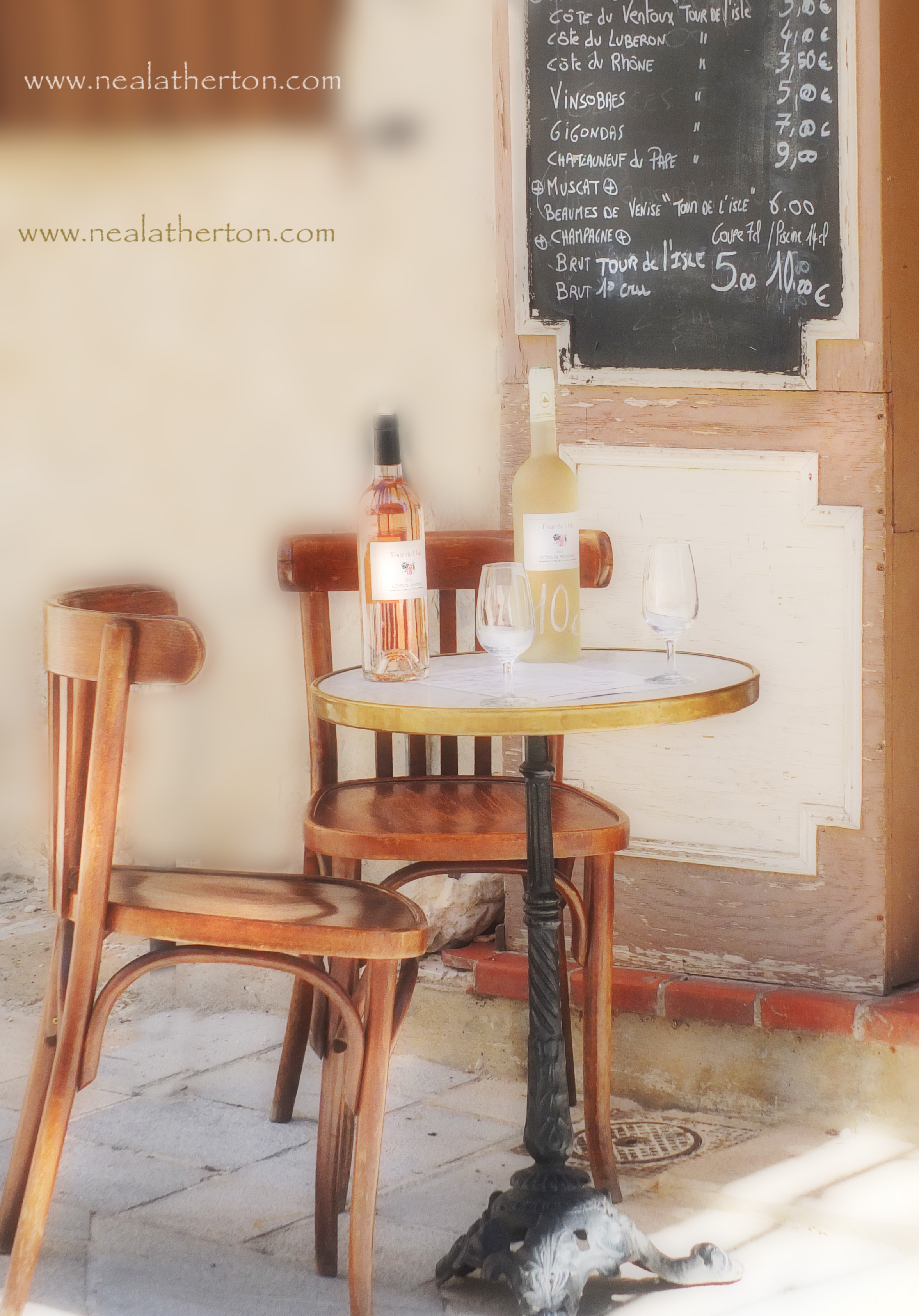 wine bottles and galsses on a table with chairs in front of wine bar menu