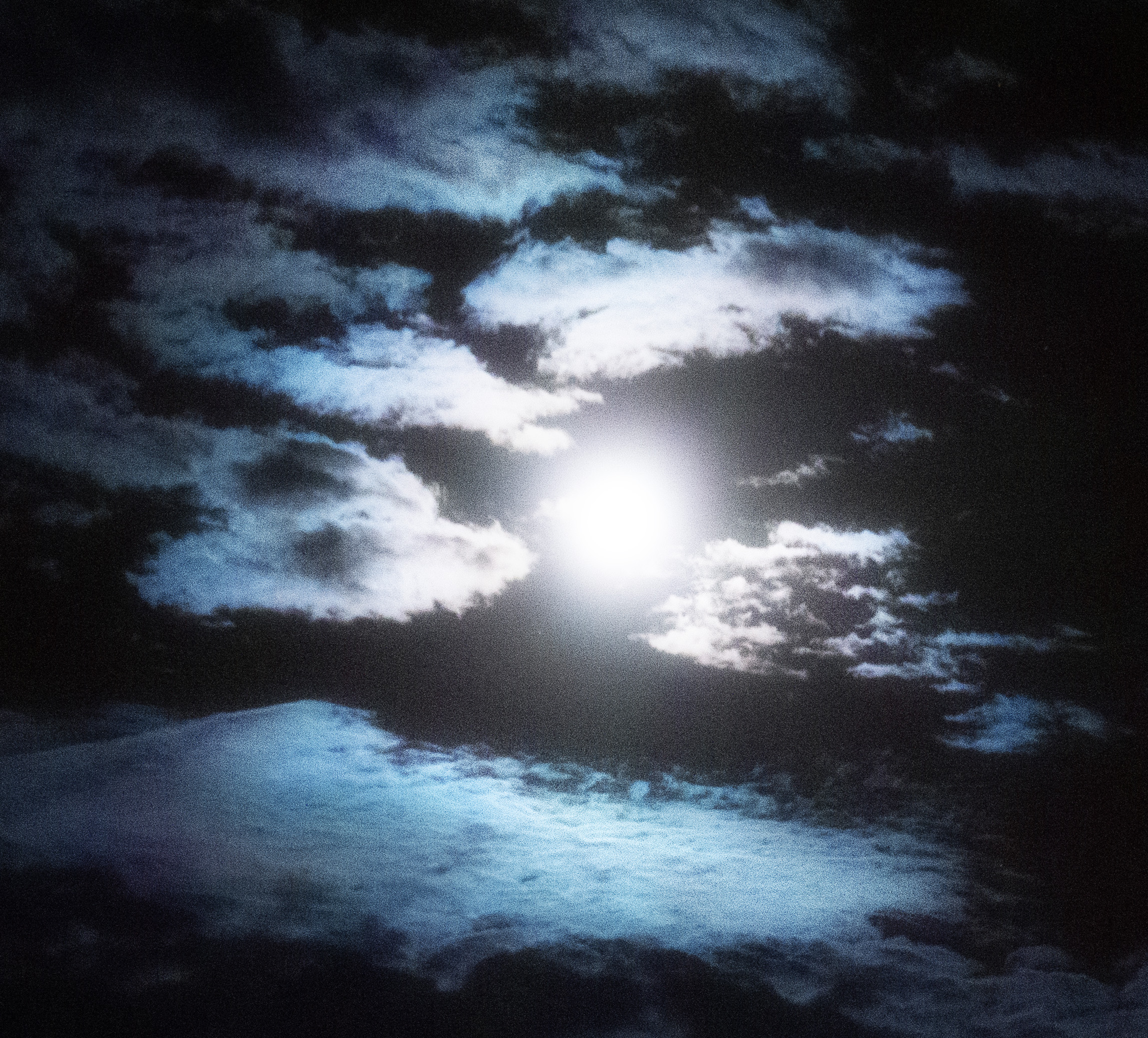 moon and clouds in black sky