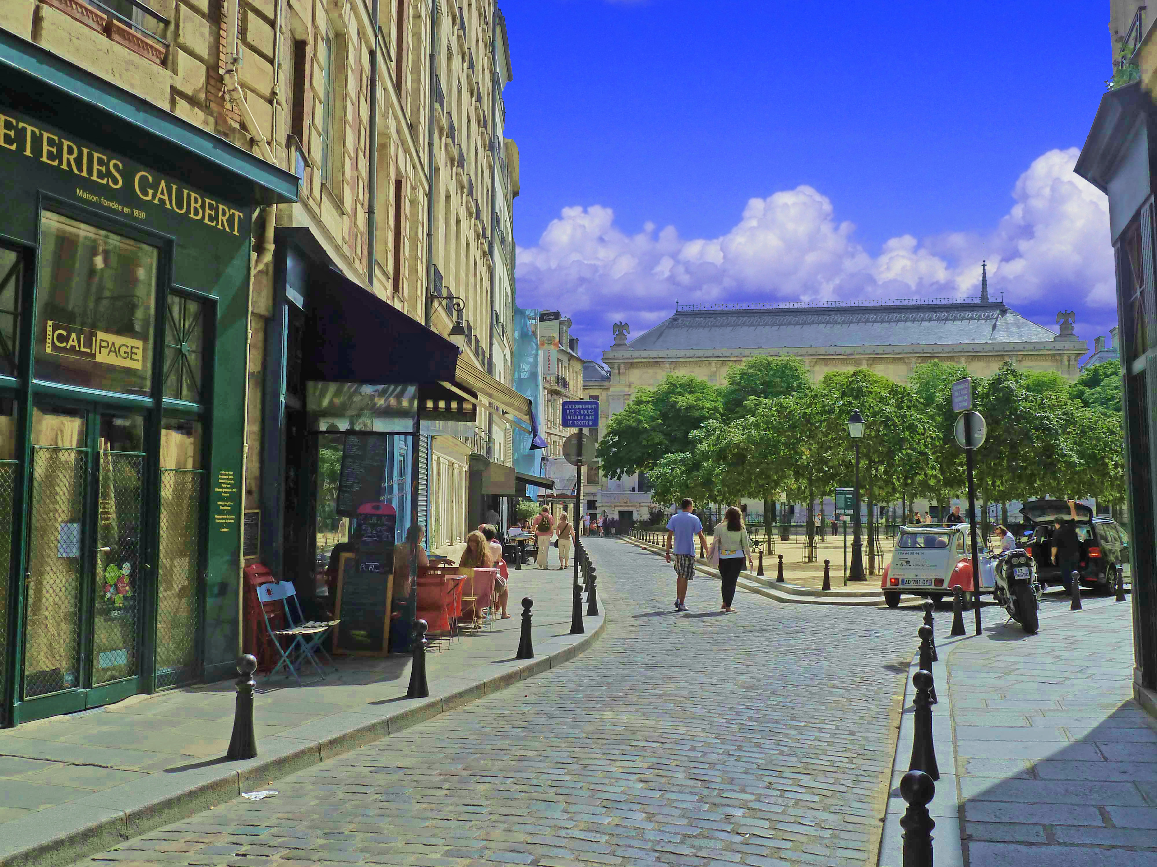 [lace in city with antique shops and restaurants with 2cv car and trees and cobbled street