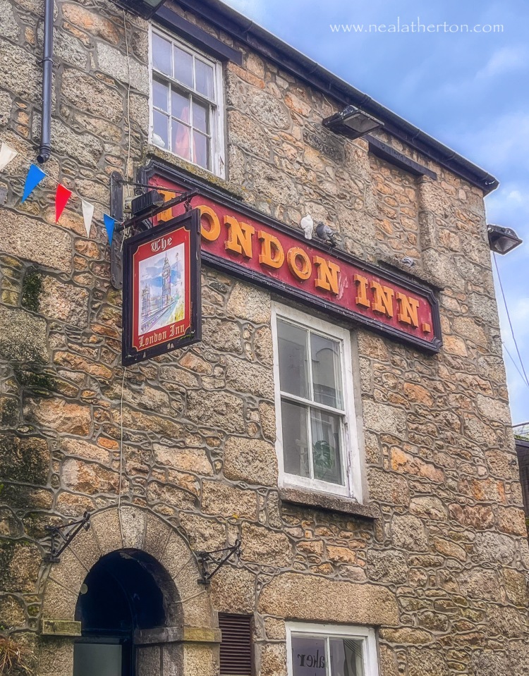 public house with sign and old stone front