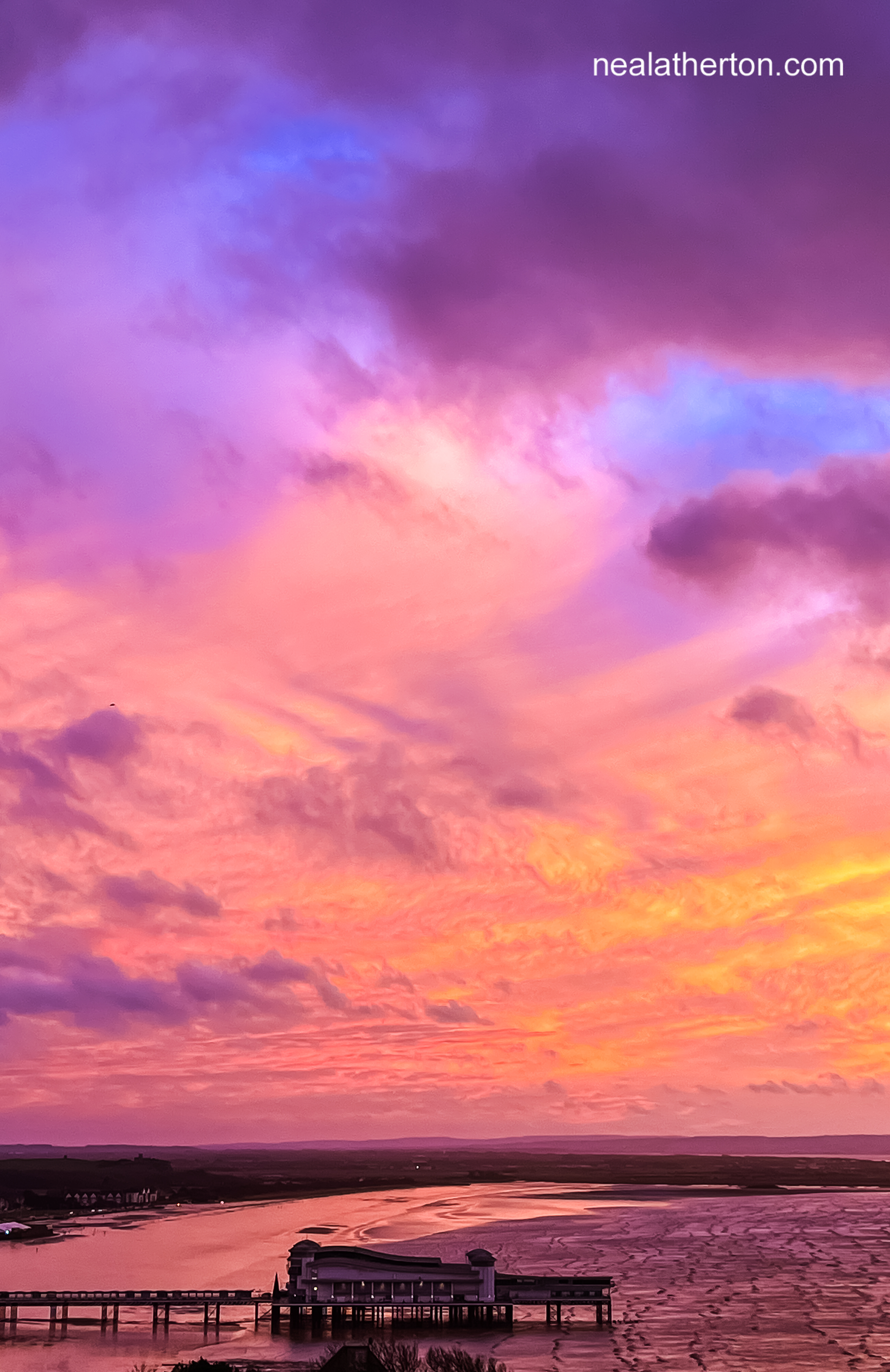 pier with sea coming in and a fiery sunset after sterm