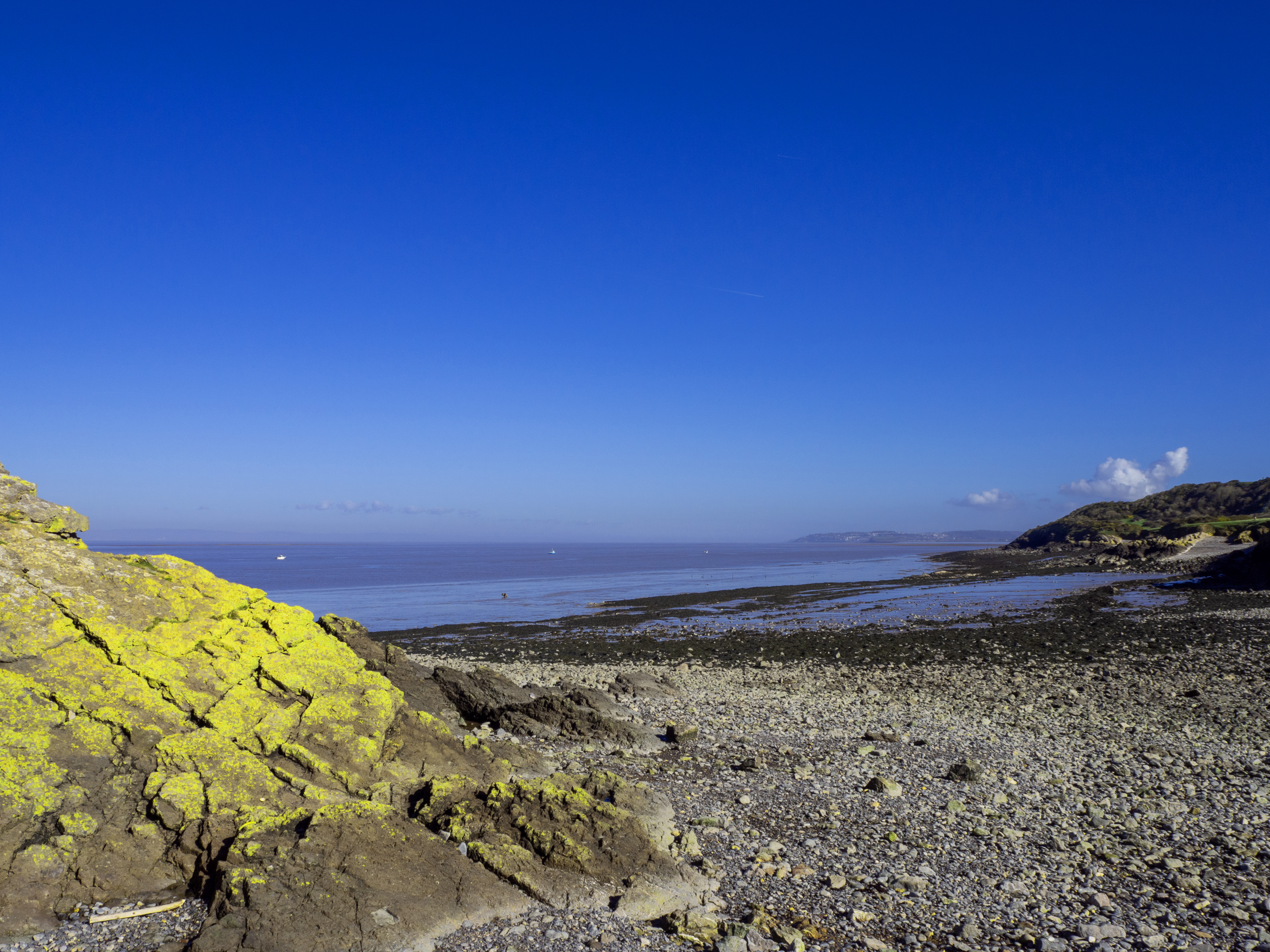 rocky shore by sea with larhe rocky outcrop