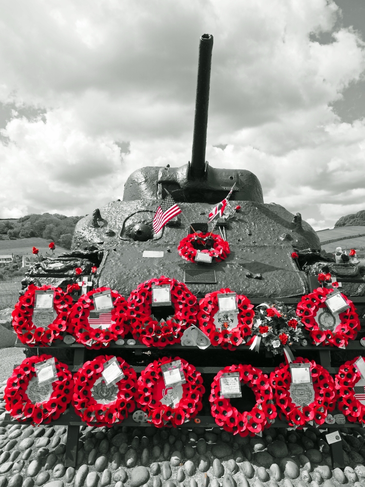 WW2 tank with wreaths and gun on cobbles