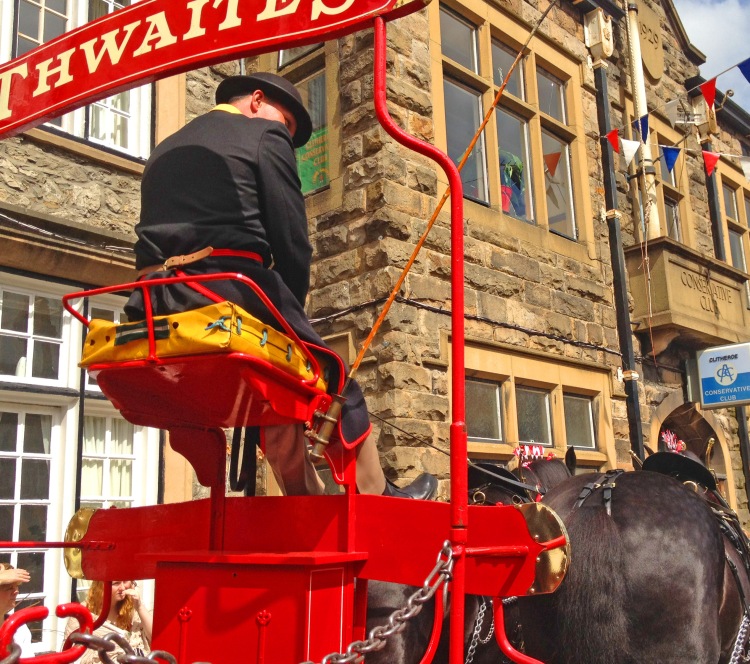 Horse with carriage and rider and red sign in front of building