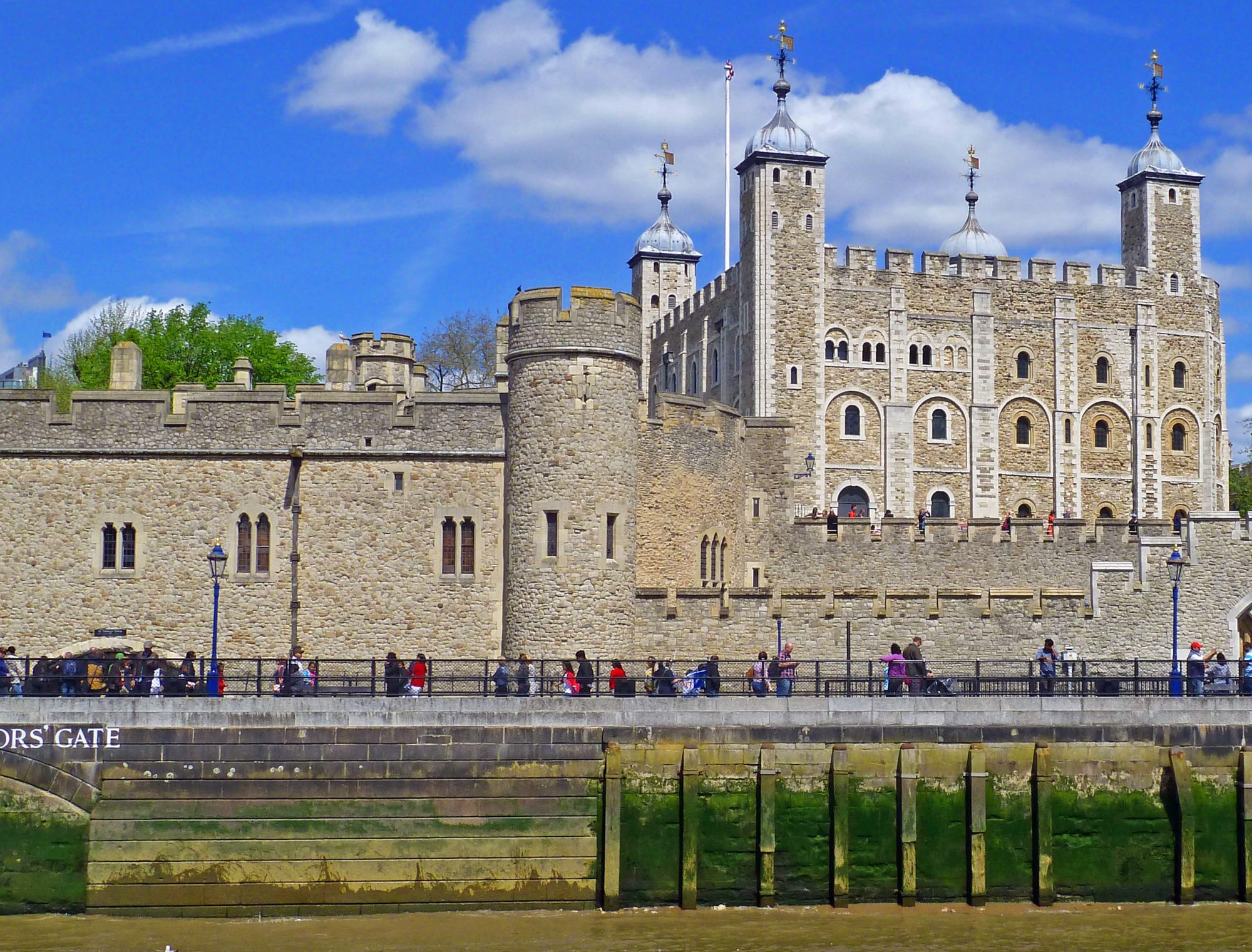 river with tower prison built in medieval times with quayside and gate with people