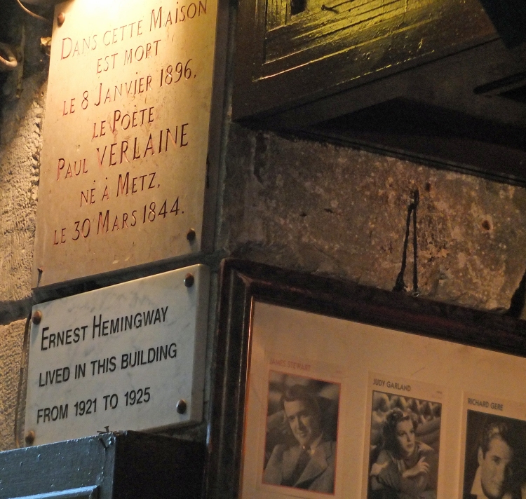 plaques to writers and photographs on wall of restaurant