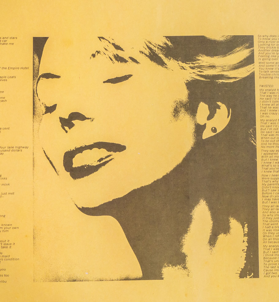 Photo of singer songwriter Joni Mitchell on a yellow album cover