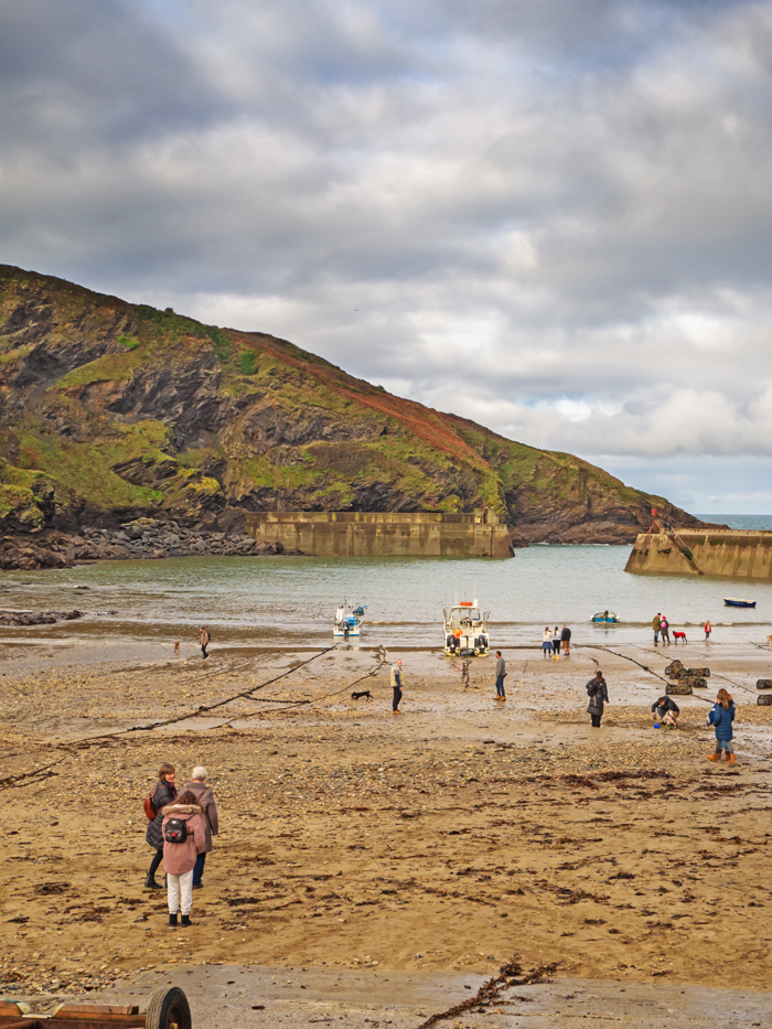 Sand beach in the harbour of Port Issac Cornwall with boats tied up at anchor