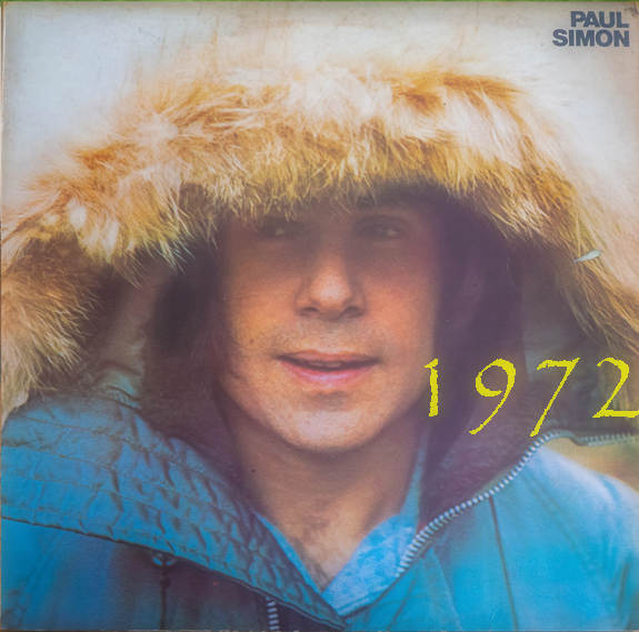 Vinyl album cover on a art easel in front of a bcakground of a baseball field